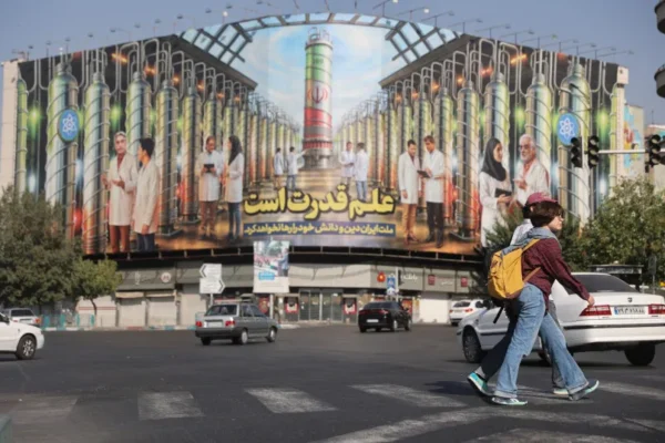 A billboard with Iranian centrifuges illustrations and portraits of nuclear scientists killed in Israeli strikes is displayed on a street in Tehran, Iran August 29, 2025 (credit: MAJID ASGARIPOUR/WANA
