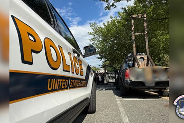 police car next to parked car with guillotine