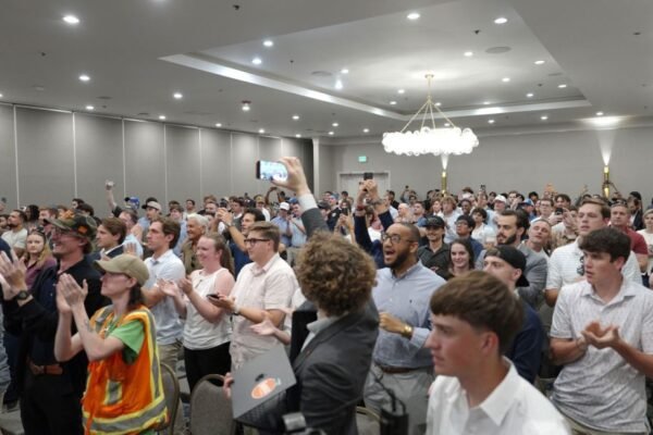 An audience of mostly young men gathers in Dallas last month to hear James Fishback, a right-wing “America First” activist who has been critical of Trump’s war in Iran.