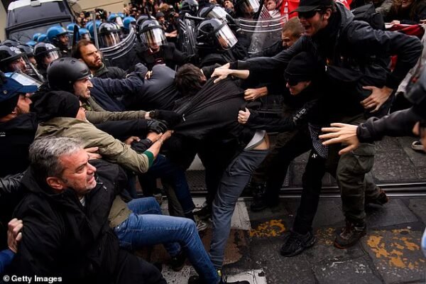 Protesters clash with riot police during a nationwide march against the rising cost of living in Turin