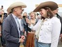 Prime Minister Mark Carney meets with Alberta Premier Danielle Smith during a Stampede breakfast at the United Brotherhood of Carpenters and Joiners of America in Calgary on July 4.