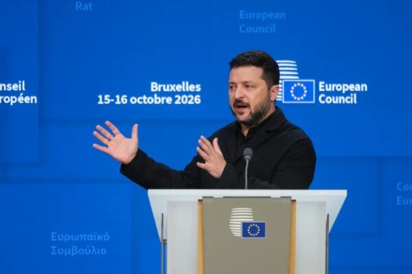 Ukrainian President Volodymyr Zelenskyy speaks at a podium during an EU Summit at the European Council in Brussels.