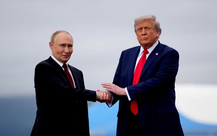 Putin, left, and Trump shake hands while standing outside