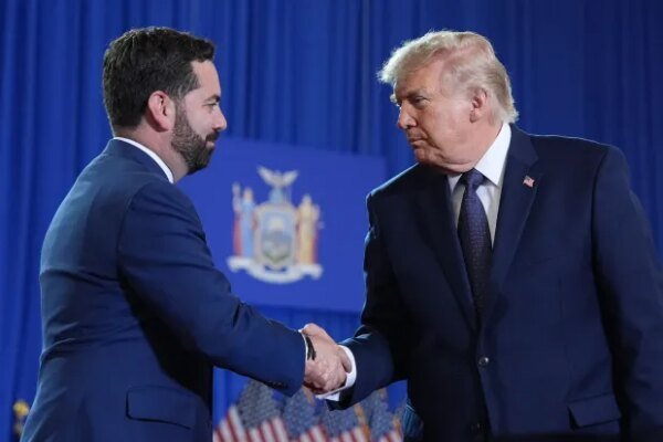 President Donald Trump shakes hands with Rep. Mike Lawler.