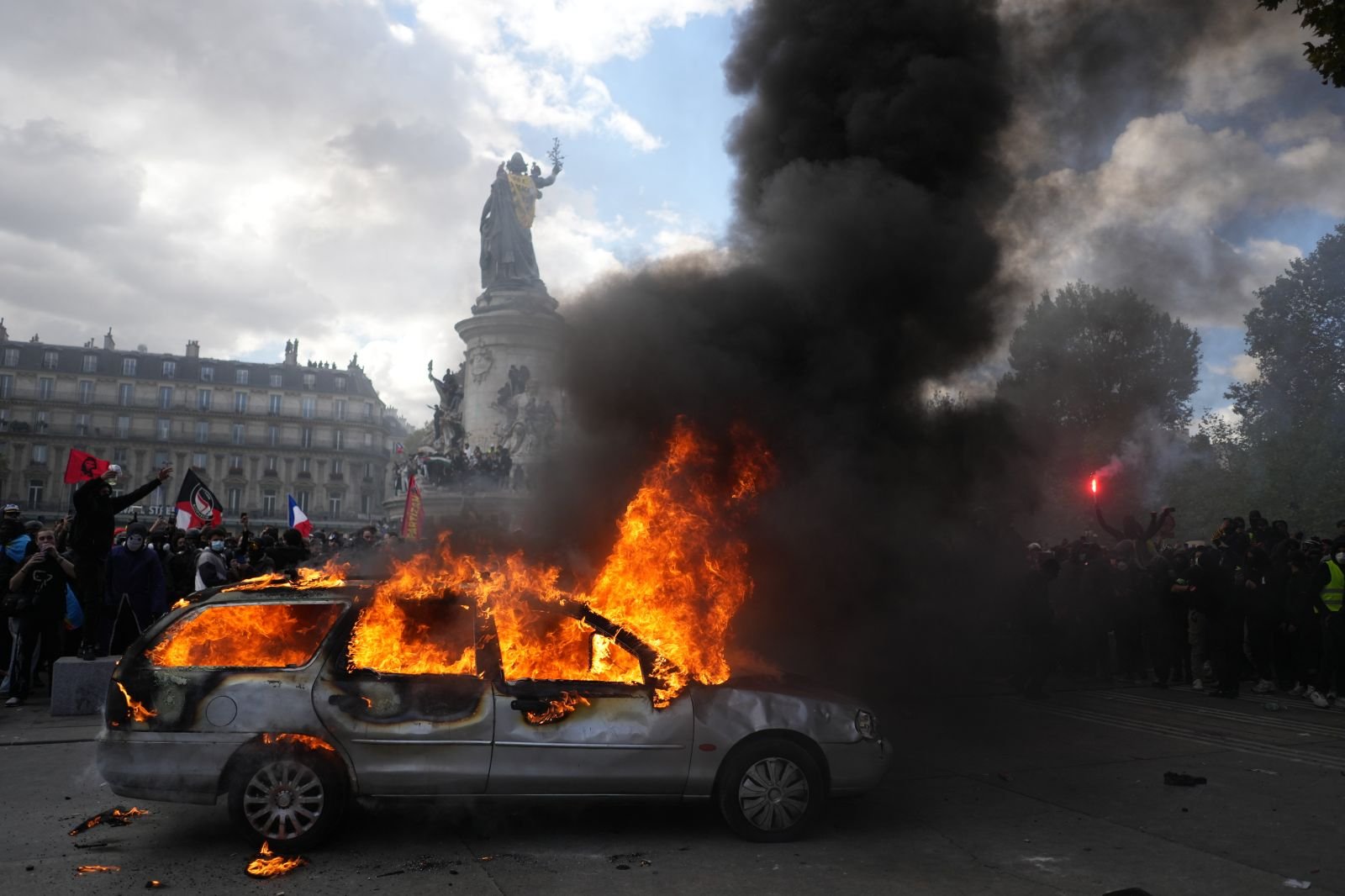 A car burns at Republique square during a protest against rising living costs, joining students' grievances, in Paris on October 17.