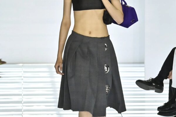 Image may contain Eugenio Montale Clothing Skirt Miniskirt Adult Person Accessories Bag and Handbag