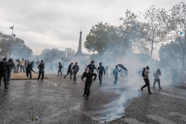 Protestors clash with the police in front of Ecole Militaire on October 13, 2026 in Paris, France.