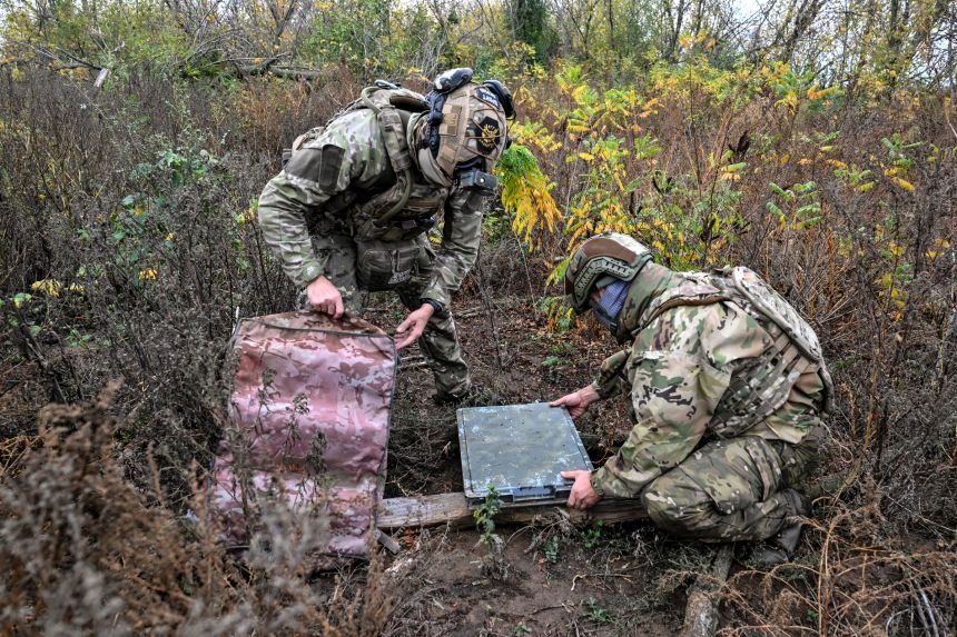 Soldiers from a battalion of the National Police of Ukraine take a camouflage case off a Starlink satellite communication terminal to be set up at a combat position in Ukraine's Donetsk region, on October 16.