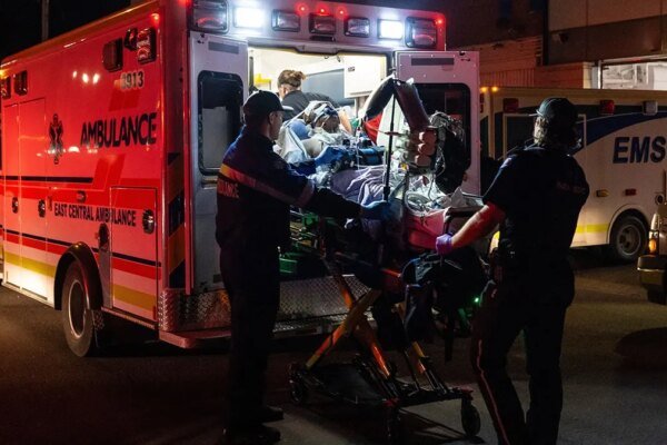 Paramedics load an injured person into an ambulance at Wainwright Health Centre.