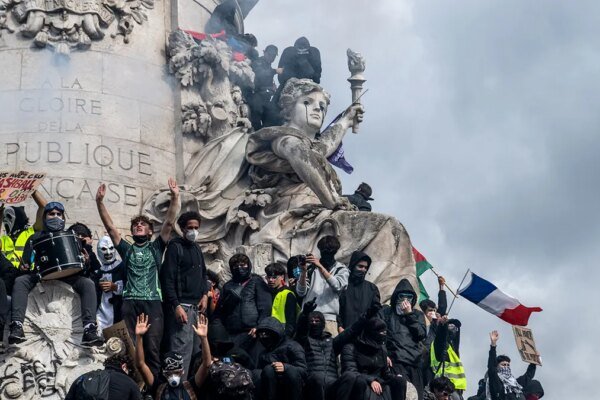 Demonstrators occupy the sculptures and ledges of the Monument a la Republique in Paris, France, on October 17, 2026.