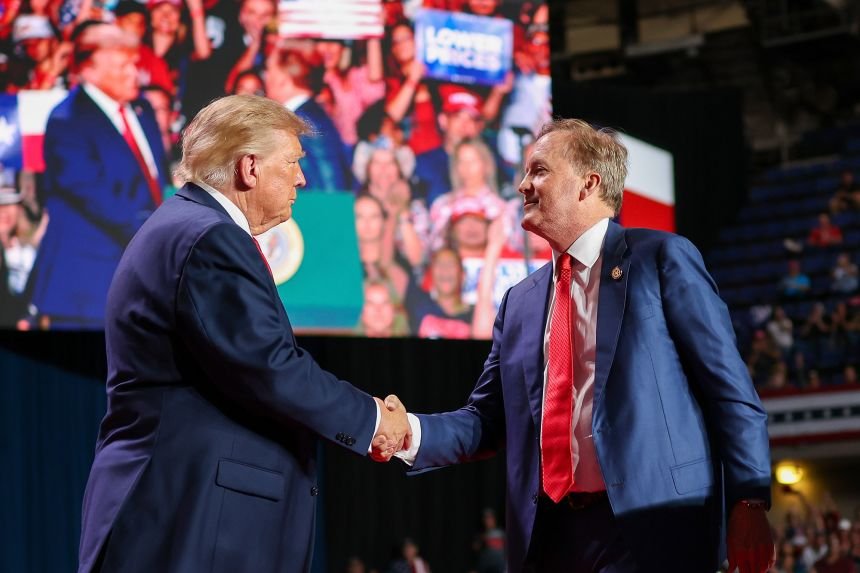 President Donald Trump shakes hands with Republican Senate candidate Texas Attorney General Ken Paxton during a campaign rally at the Freeman Coliseum in San Antonio, Texas, October 7.