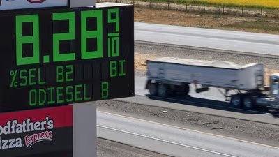 A semi drives past a sign advertising the price of diesel along Interstate 5 in Williams, Calif., Sept. 28.