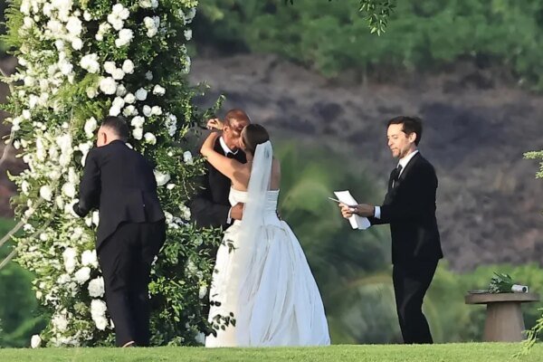Jennifer Meyer and Geoff Ogunlesi embrace at their wedding ceremony, officiated by Tobey Maguire.