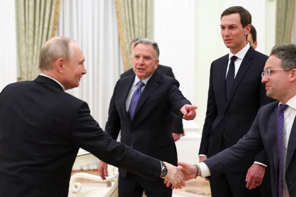 Russia’s president stands alongside U.S. representatives during a formal meeting inside a government setting.