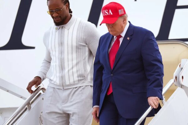 Donald Trump and Todd Gurley walk off Air Force One in Marietta, Georgia.