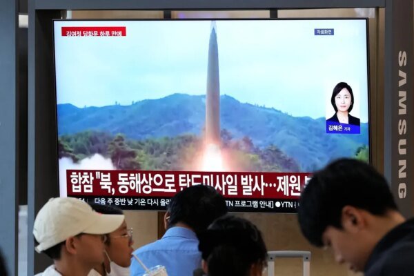 A TV screen showing a North Korean missile launch during a news program at Seoul Railway Station in South Korea.